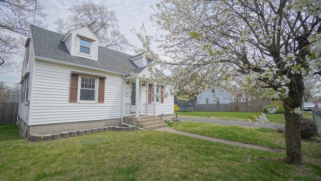 a backyard of a house with lots of green space and outdoor seating