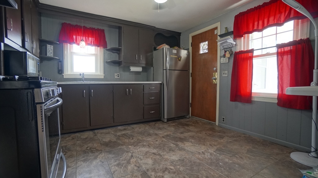 41 Parallel Street Springfield, MA 01104 - Photo 16 of 35 a kitchen with refrigerator cabinets and a window