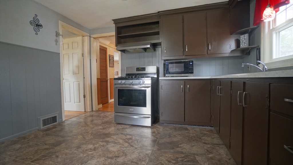 41 Parallel Street Springfield, MA 01104 - Photo 17 of 35 a kitchen with stainless steel appliances granite countertop a refrigerator and a stove top oven