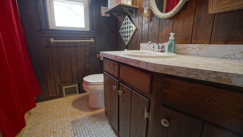 41 Parallel Street Springfield, MA 01104 - Photo 19 of 35 a bathroom with a sink a toilet and a mirror