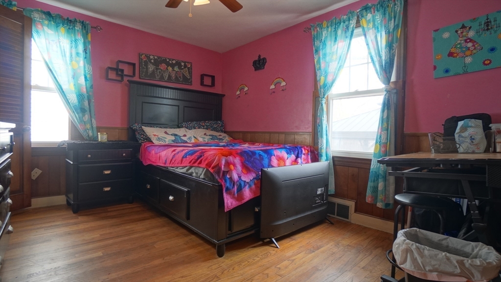 41 Parallel Street Springfield, MA 01104 - Photo 24 of 35 a bedroom with a bed and a dresser next to a window