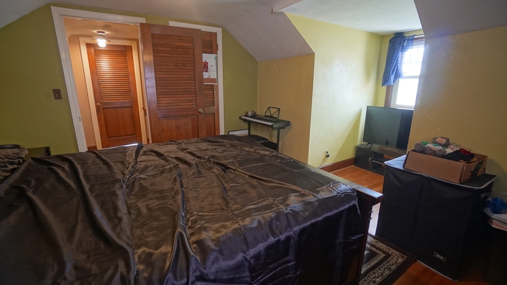 41 Parallel Street Springfield, MA 01104 - Photo 27 of 35 a bedroom with a bed and wooden floor