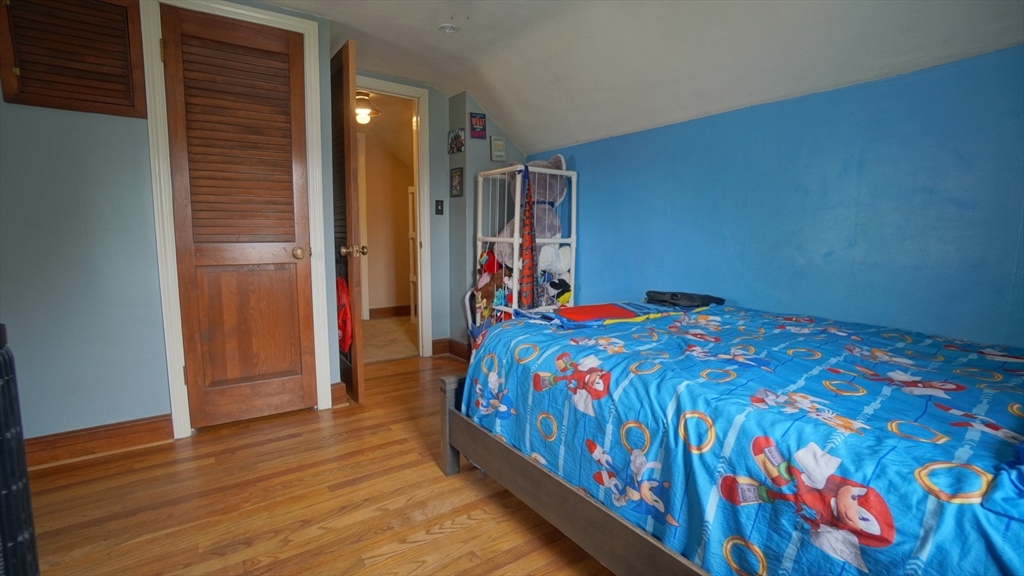 41 Parallel Street Springfield, MA 01104 - Photo 32 of 35 a bedroom with a bed and wooden floor
