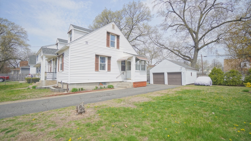 41 Parallel Street Springfield, MA 01104 - Photo 4 of 35 a front view of a house with a yard and garage