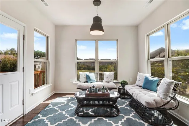 a living room with furniture a wooden floor and a sink