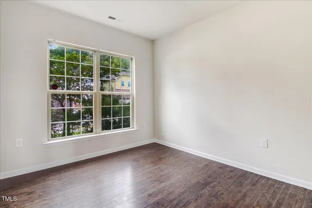 a view of an empty room and wooden floor