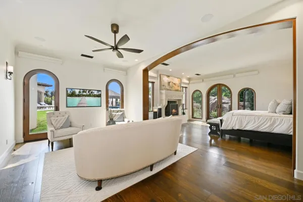 a spacious bedroom with a bed and a fireplace