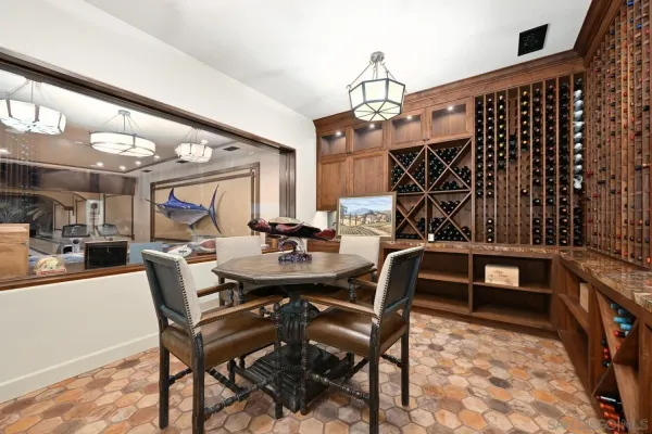 a view of a dining room with furniture chandelier and fireplace