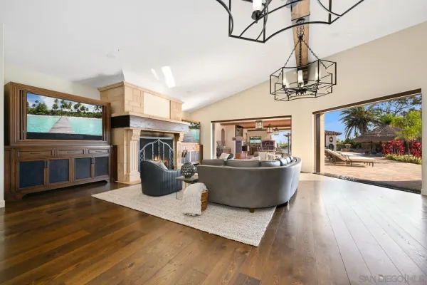 a living room with fireplace furniture and a large window