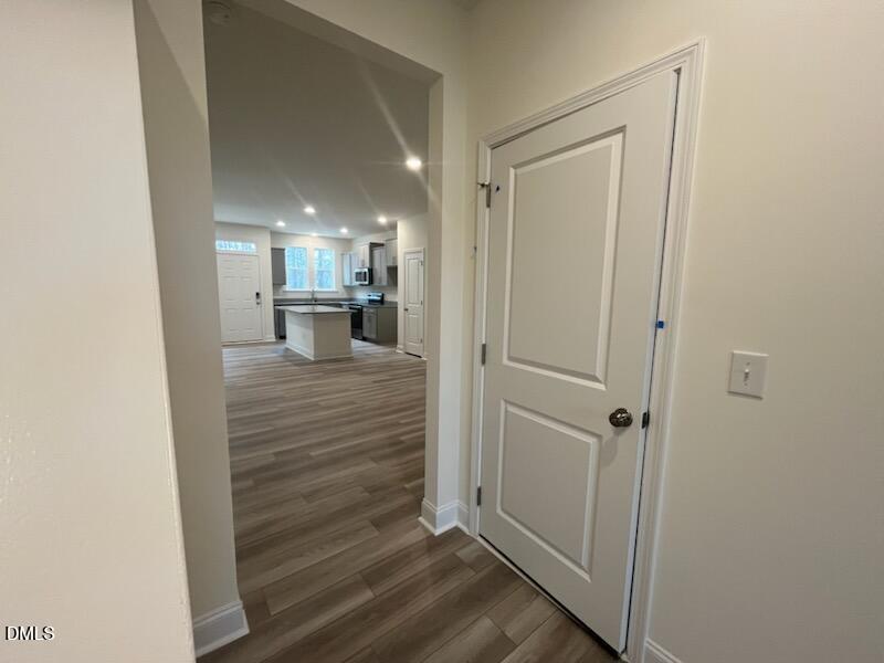 6431 Granite Quarry Drive Raleigh, NC 27610 - Photo 19 of 59 a view of a hallway with wooden floor