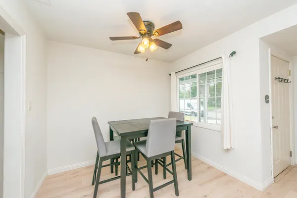 a dining room with furniture and window