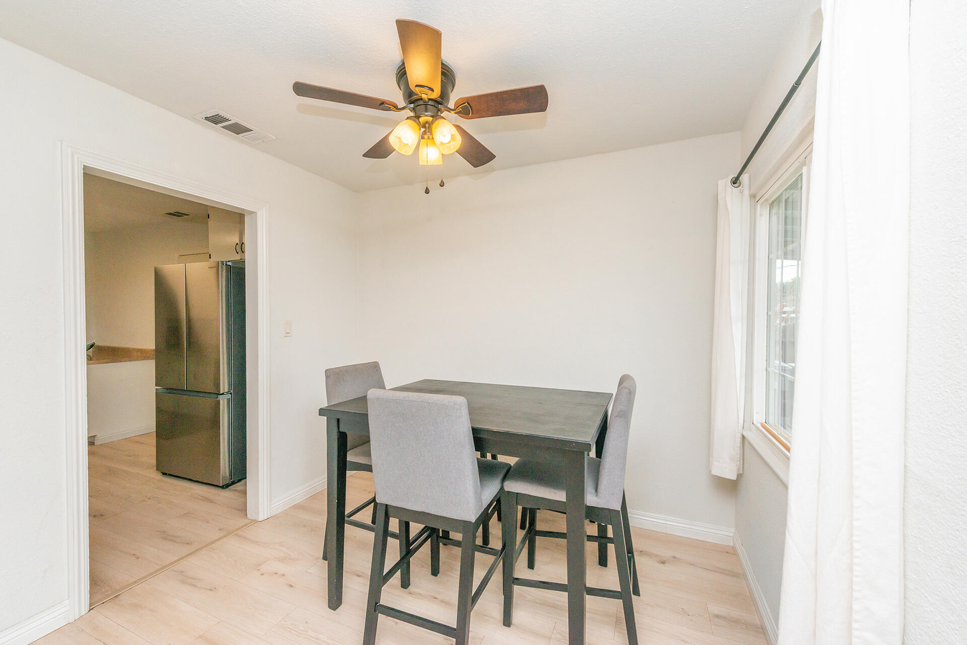 1115 2nd Street Redding, CA 96002 - Photo 15 of 39 a view of a dining room with furniture and a chandelier fan