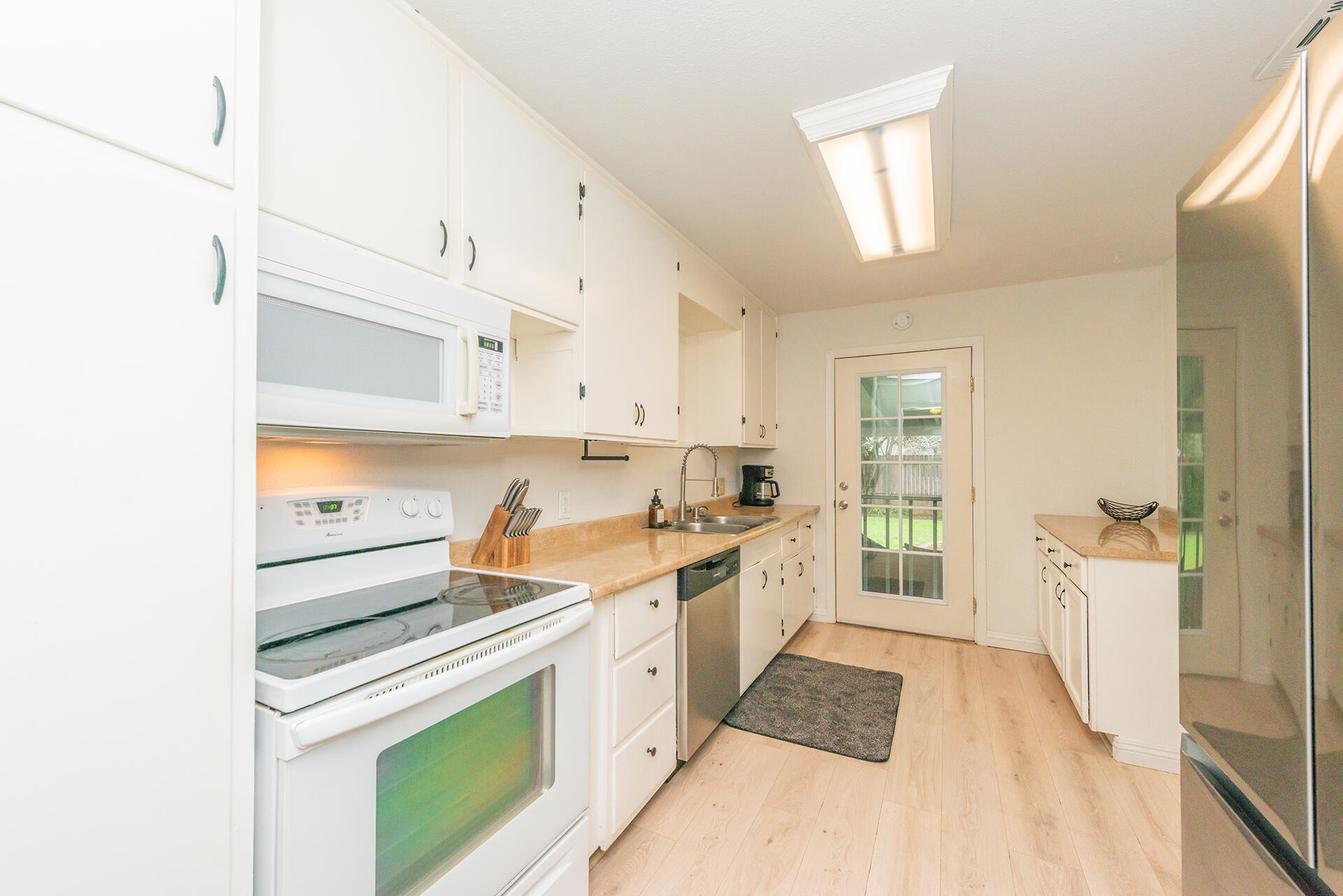 1115 2nd Street Redding, CA 96002 - Photo 17 of 39 a kitchen with a sink stove and refrigerator