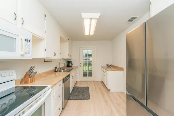 a kitchen with a sink stove and refrigerator