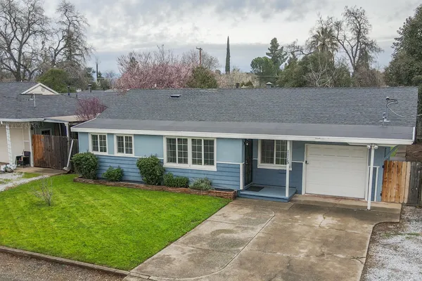 a view of house with a yard
