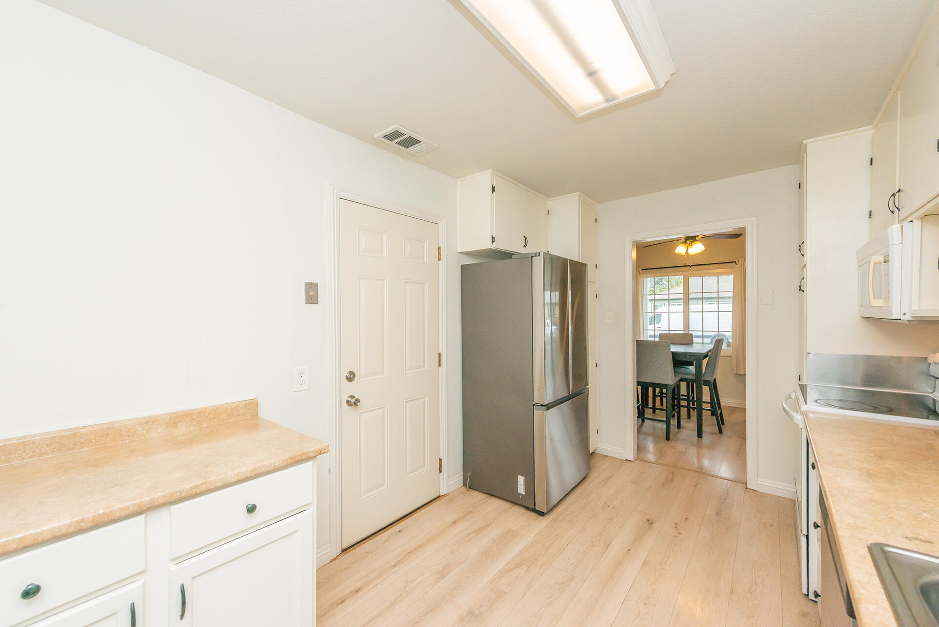 1115 2nd Street Redding, CA 96002 - Photo 21 of 39 a kitchen with granite countertop a refrigerator and a stove top oven