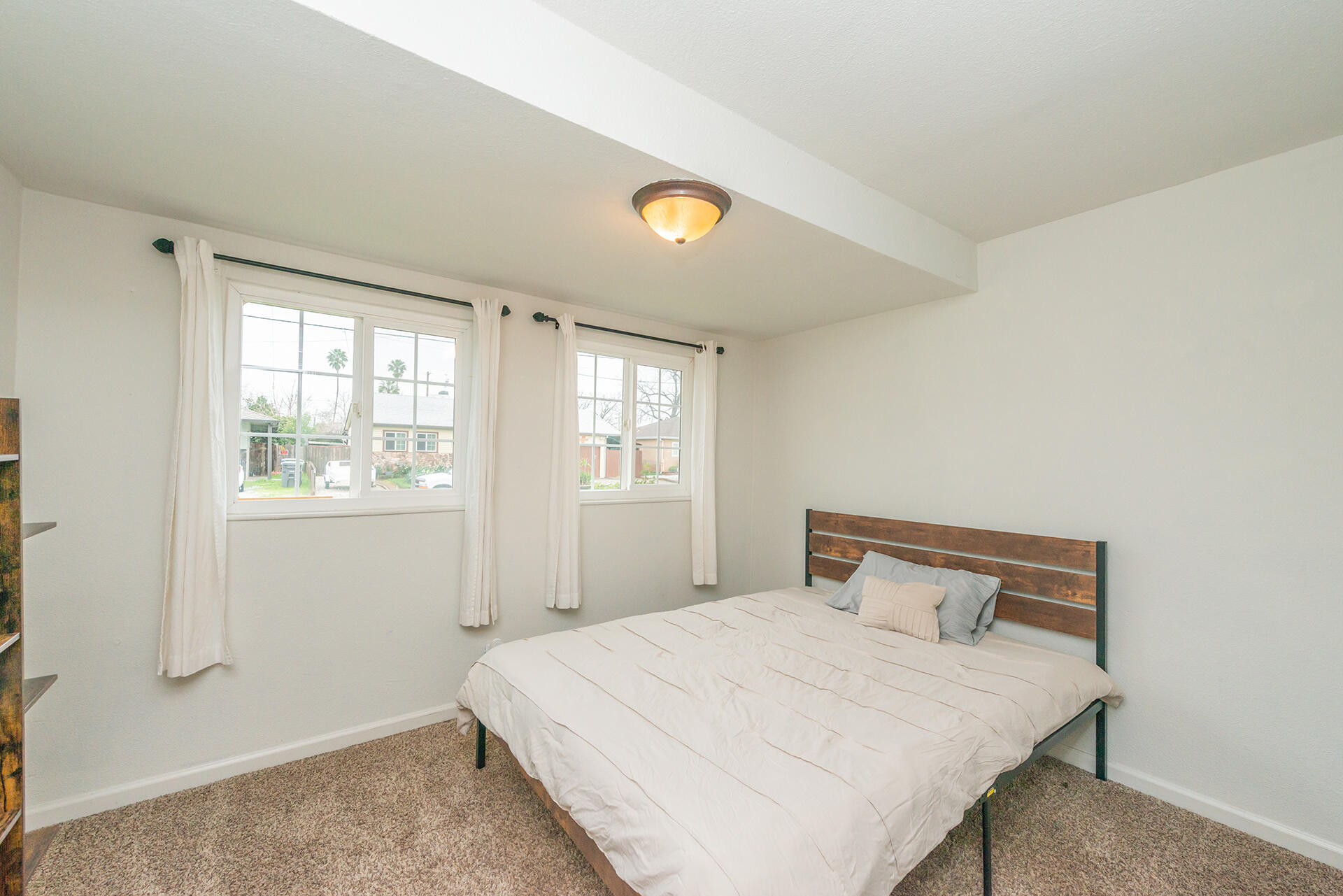 1115 2nd Street Redding, CA 96002 - Photo 22 of 39 a bedroom with a bed and window