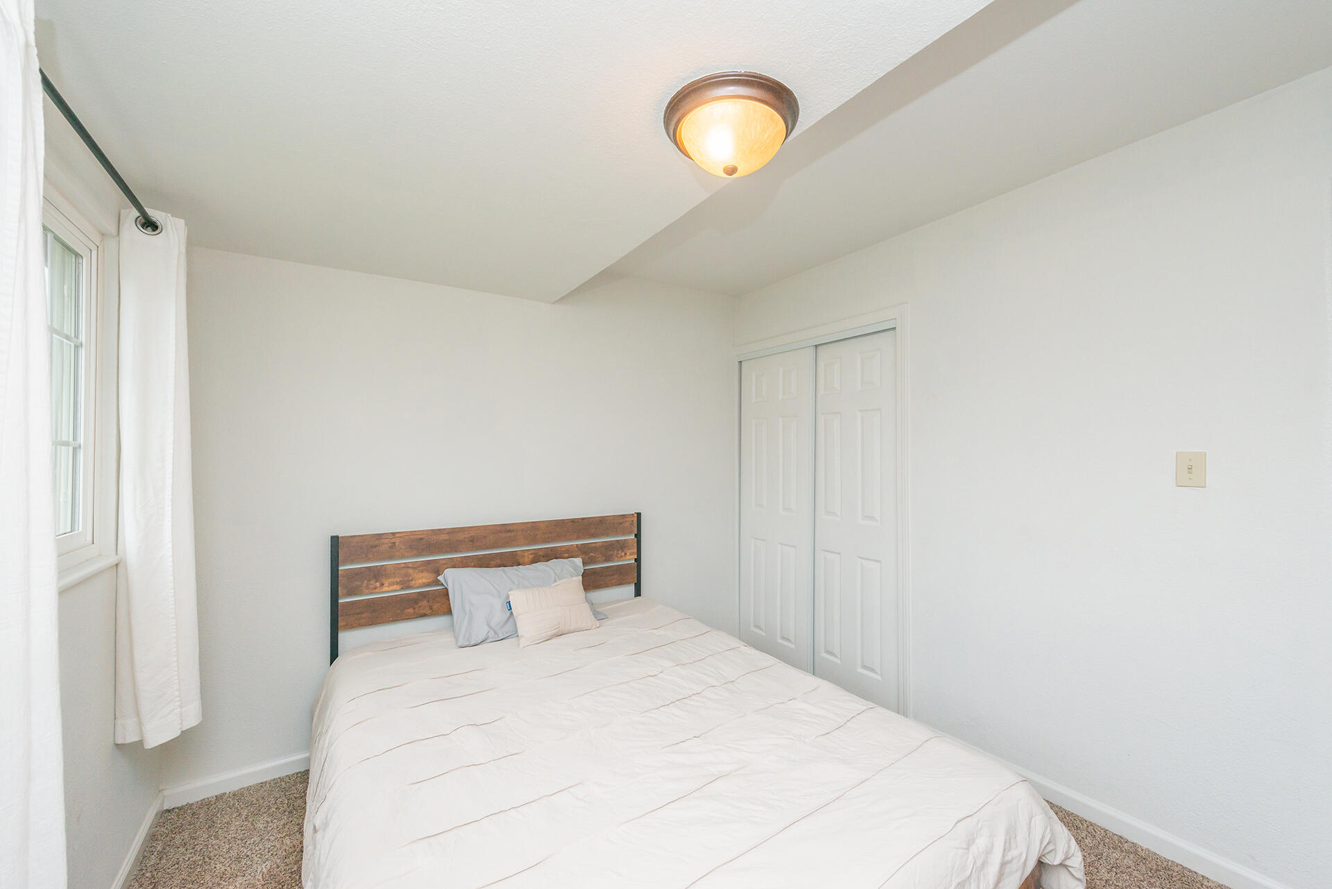 1115 2nd Street Redding, CA 96002 - Photo 23 of 39 a bedroom with a bed and a window