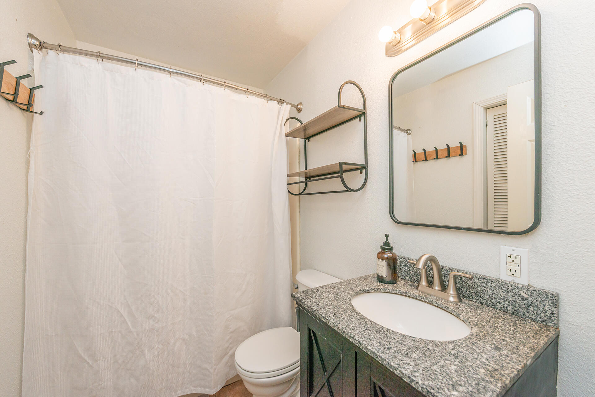 1115 2nd Street Redding, CA 96002 - Photo 24 of 39 a bathroom with a granite countertop sink mirror vanity and toilet