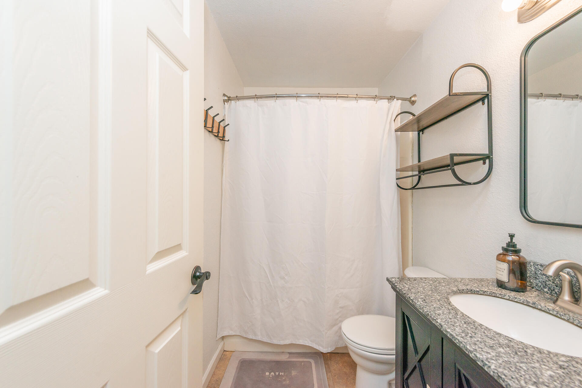 1115 2nd Street Redding, CA 96002 - Photo 25 of 39 a bathroom with a granite countertop sink toilet and shower