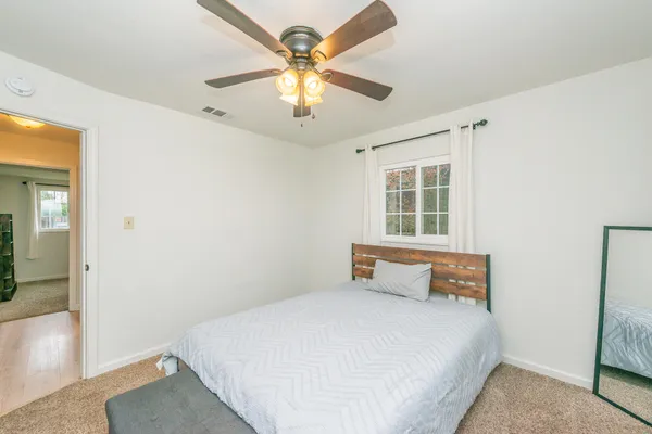 a bedroom with a bed and a window