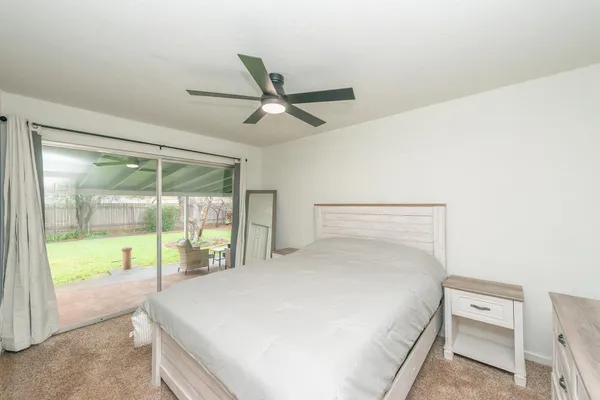 a bed room with a bed and a large window