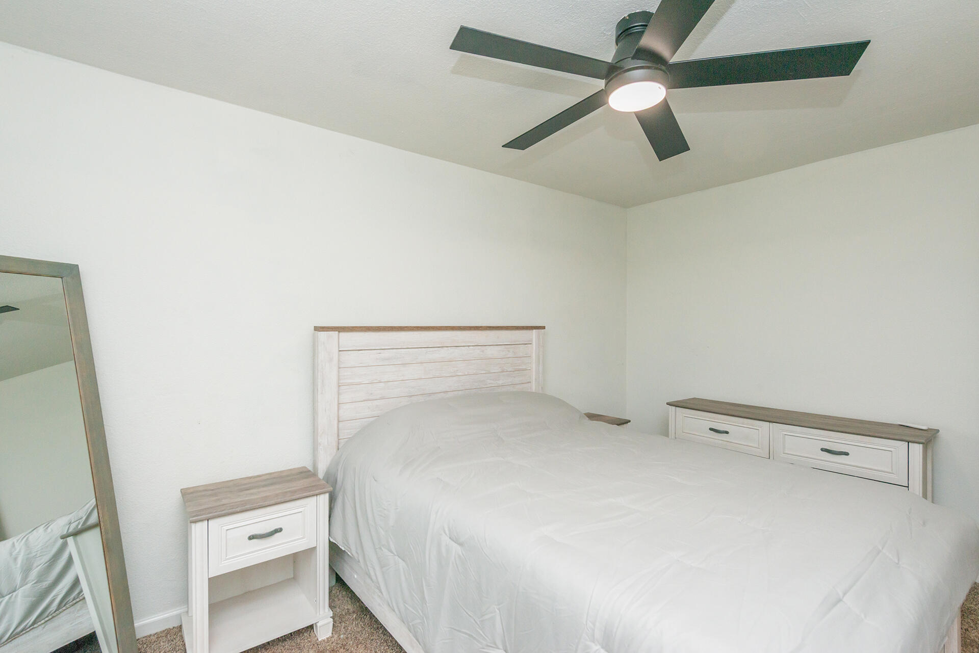 1115 2nd Street Redding, CA 96002 - Photo 29 of 39 a bedroom with a bed and a ceiling fan