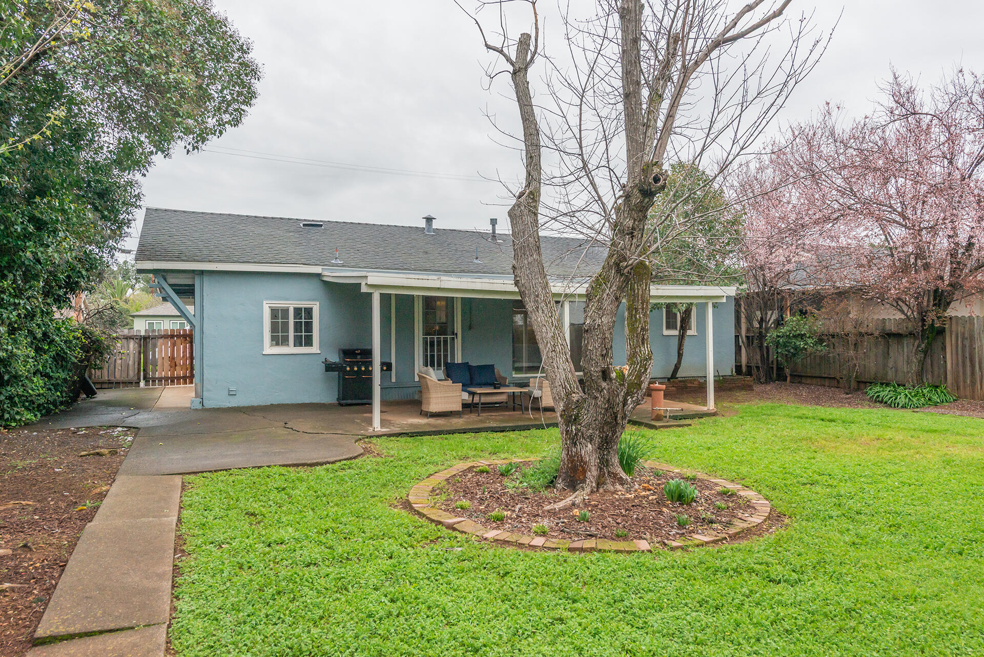 1115 2nd Street Redding, CA 96002 - Photo 36 of 39 a front view of a house with a yard garden and outdoor seating