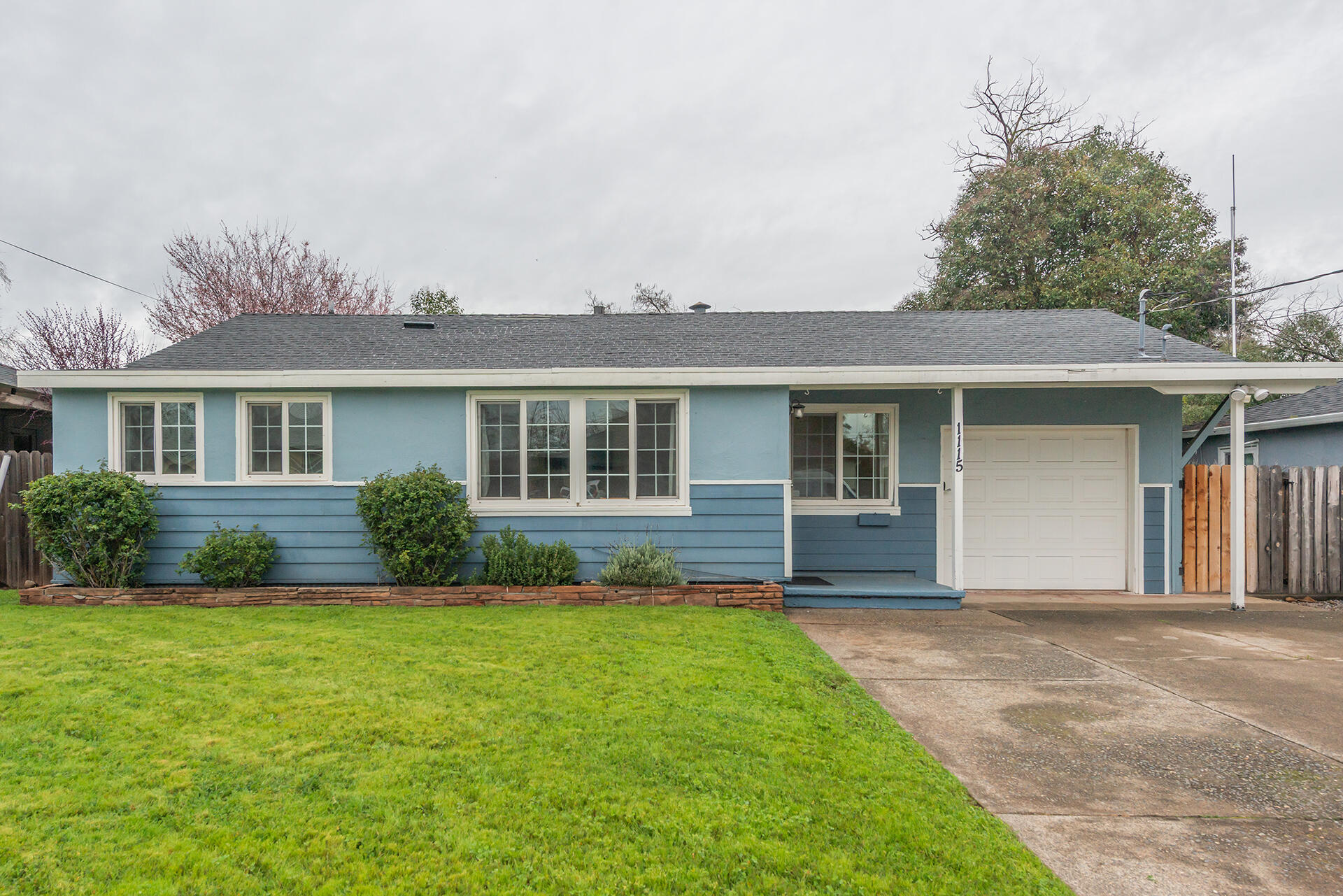 1115 2nd Street Redding, CA 96002 - Photo 4 of 39 a front view of a house with a garden and yard