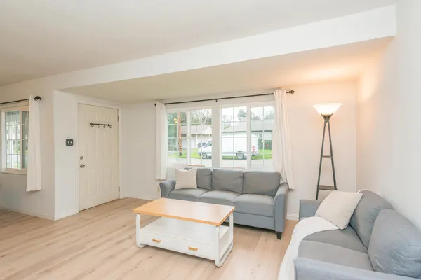 a living room with furniture and a large window