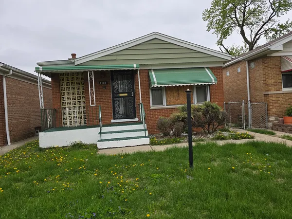 a front view of a house with a yard and outdoor seating