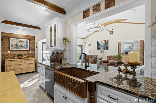 a kitchen with stainless steel appliances a sink stove and cabinets