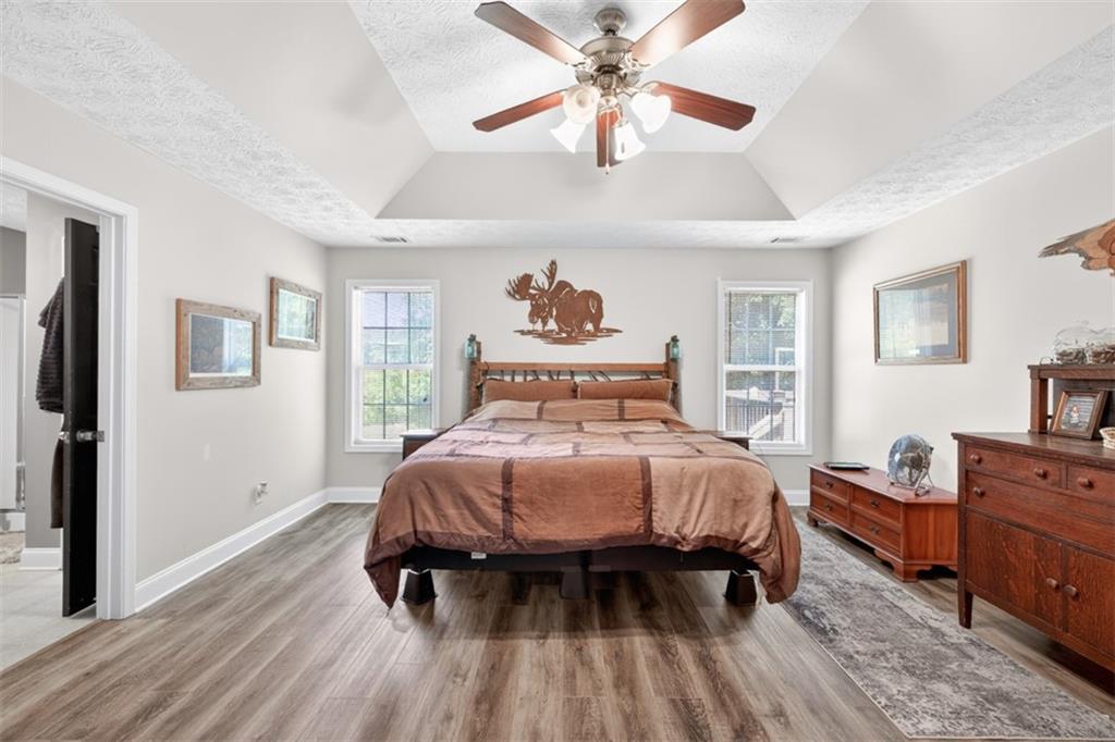 89 Katie Spring Lane Jefferson, GA 30549 - Photo 33 of 63 a bedroom with a bed and wooden floor