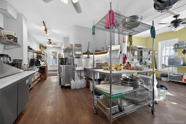 a room with lots of wooden furniture and a chandelier