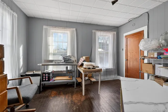 a living room with furniture a dining table and wooden floor