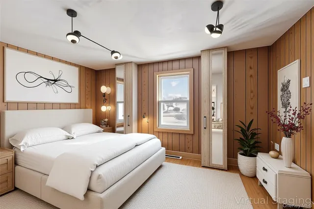 a bedroom with a large bed and a chandelier