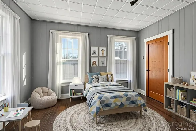 a bedroom with bed and a large window