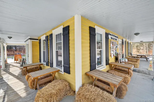 a bedroom with furniture and large windows