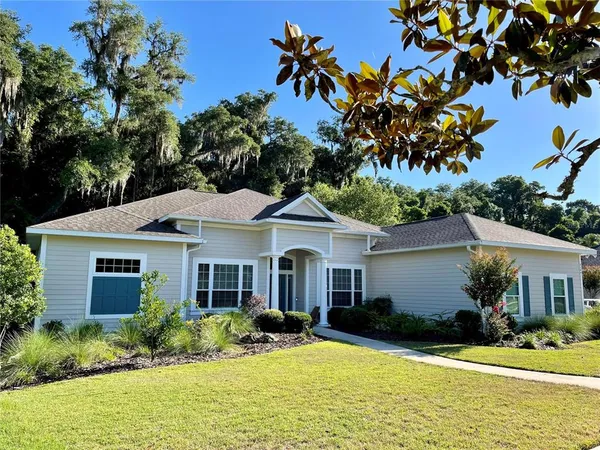 a front view of house with yard and green space