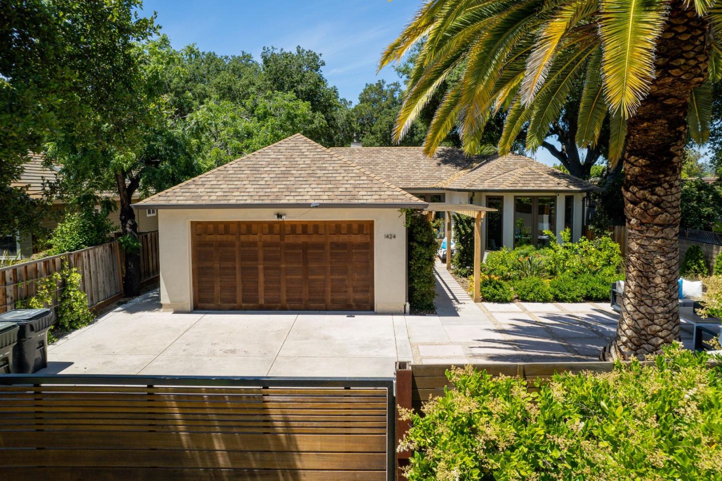 a view of a house with a yard and potted plants