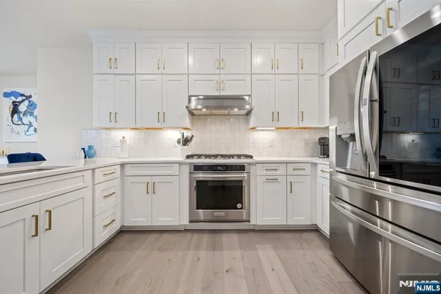 a kitchen with cabinets appliances and a center island
