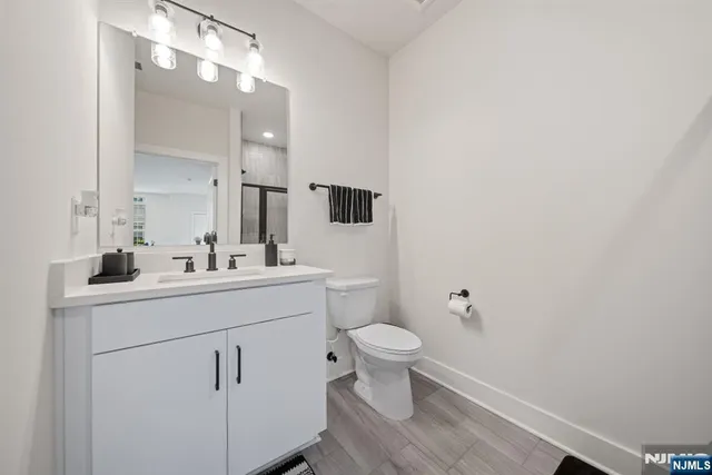 a bathroom with a sink toilet a mirror and vanity