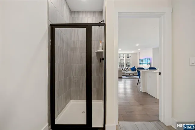 a view of a hallway with dining area and chandelier