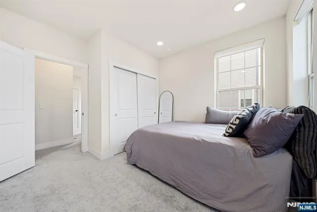 a bathroom with a sink a toilet a mirror and shower