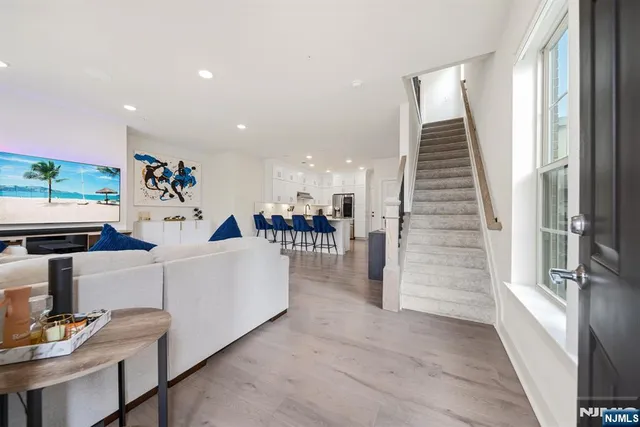 a living room with furniture and kitchen view