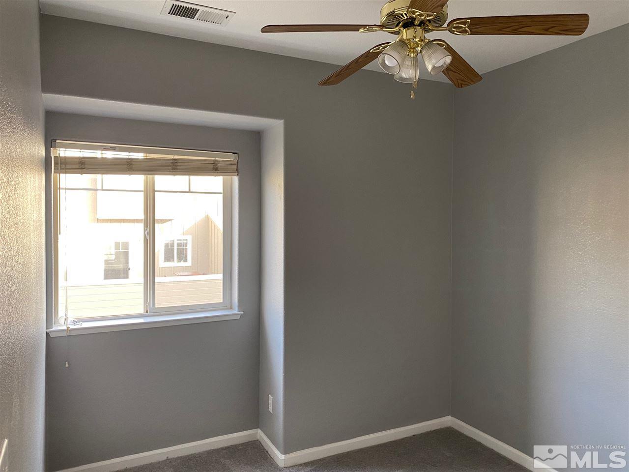 4150 Amber Marie Lane Reno, NV 89503 - Photo 11 of 16 an empty room with a window and a fan
