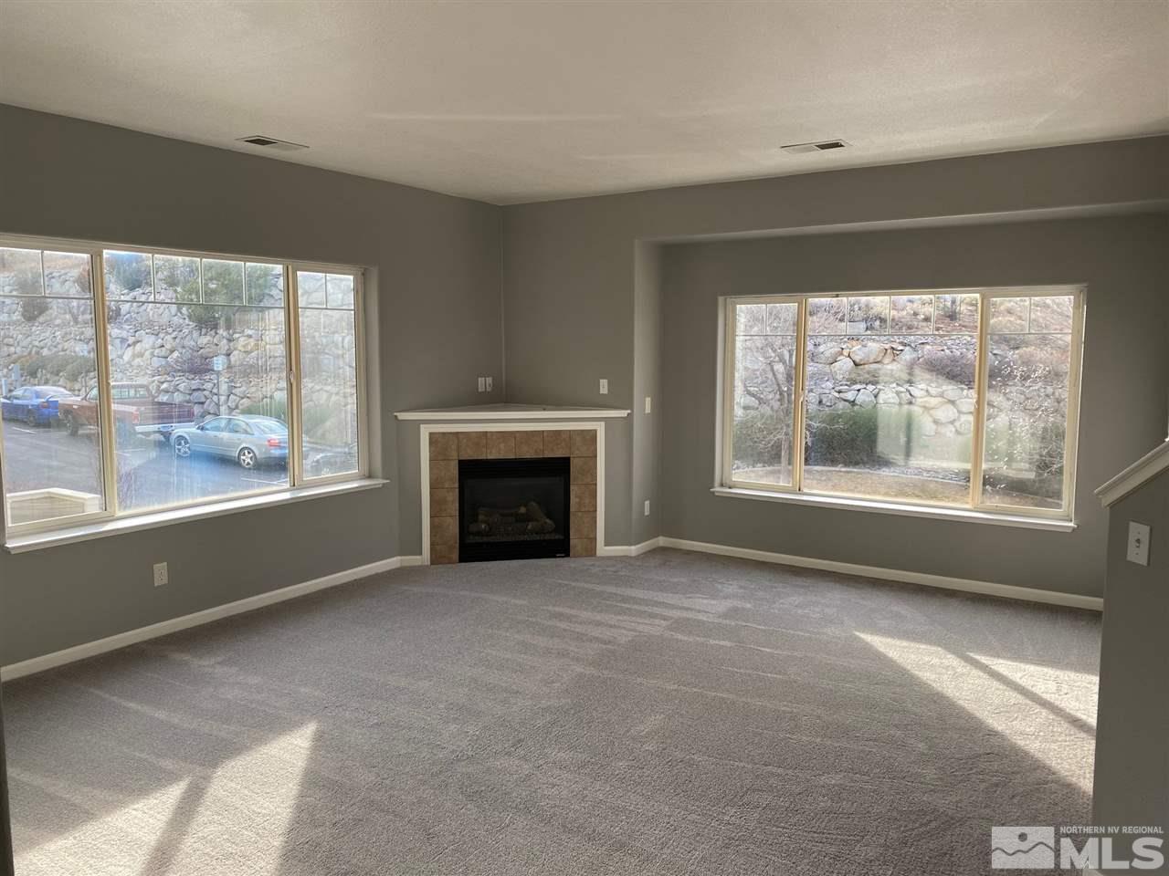 4150 Amber Marie Lane Reno, NV 89503 - Photo 4 of 16 a view of empty room with window and fireplace