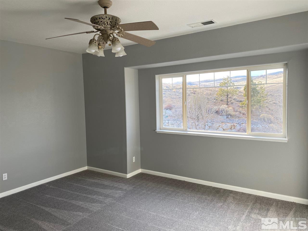 4150 Amber Marie Lane Reno, NV 89503 - Photo 7 of 16 an empty room with a window and a fan