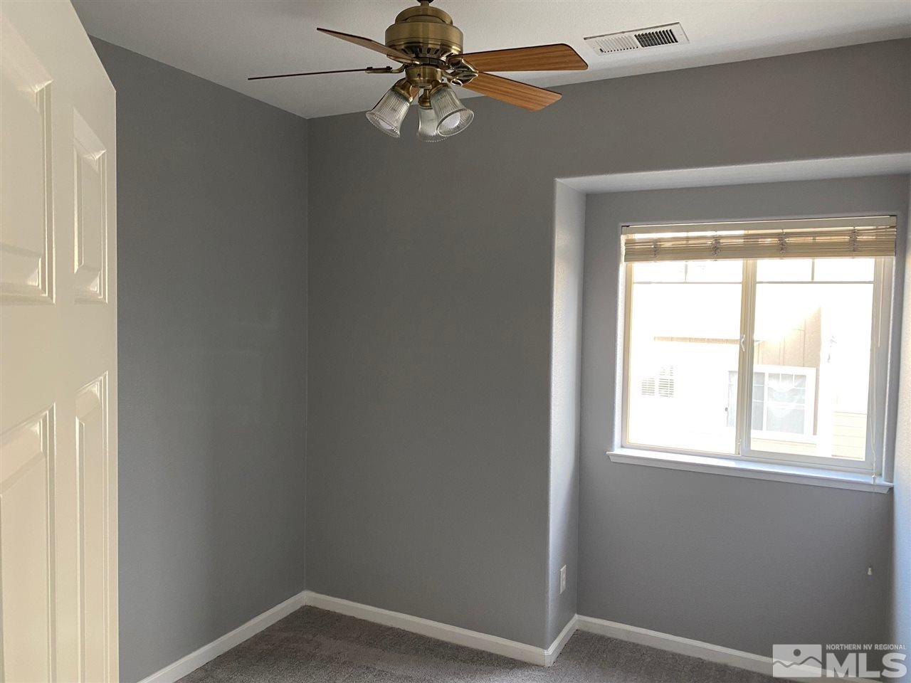 4150 Amber Marie Lane Reno, NV 89503 - Photo 9 of 16 an empty room with a window and a fan