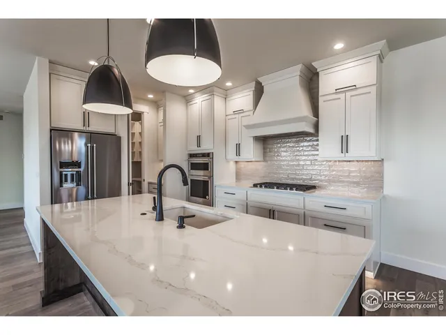 a kitchen with cabinets appliances and a counter space
